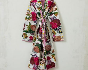 May include: A white floral print robe with a pink and white trim. The robe has a long sleeve and a tie belt.
