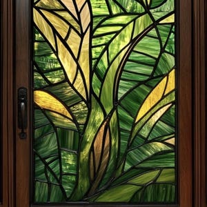 Puede incluir: Una puerta de vidrio emplomado con un diseño de hojas verdes y amarillas.