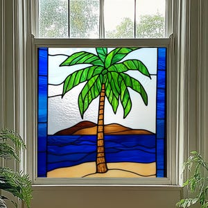May include: Stained glass window panel featuring a tropical beach scene. A green palm tree stands on a sandy shore, with a blue ocean and brown hills in the background. The panel is framed by a blue border.