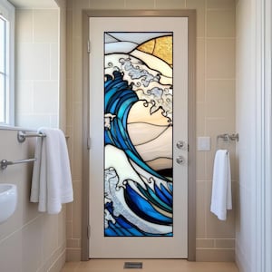 May include: A white door with a stained glass panel featuring a stylized ocean wave design. The wave is depicted in shades of blue, white, and silver, with a golden sun in the background. The door is in a bathroom setting.