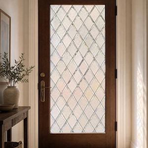 May include: A dark brown wooden door featuring a large central glass panel with a diamond-shaped grid pattern. The glass has a textured, semi-opaque finish. The door is equipped with a brass-toned handle and a matching circular deadbolt lock.