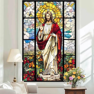 May include: A stained glass window depicting Jesus Christ in a red and white robe, standing in a garden with flowers. The window is framed in black and has a gold halo around Jesus' head.