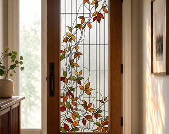 May include: A wooden front door featuring a large glass panel with a stained glass design of climbing vines and autumn-colored leaves in shades of red, orange, yellow, and green, set against a clear, textured glass background with grid lines.