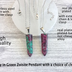 May include: Two Ruby in Green Zoisite pendants with silver chains. The pendants are rectangular with red and green hues. The chains have lobster clasps. Text on the image reads "High Quality" and "Ruby in Green Zoisite Pendant with a choice of chains."