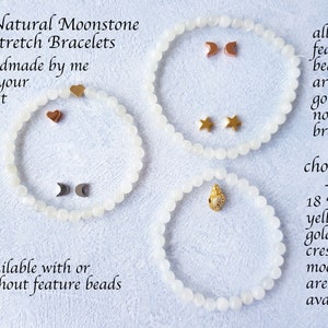May include: Three natural moonstone stretch bracelets with feature beads. The bracelets are handmade and available with or without feature beads. Feature beads include gold-plated crescent moons, stars, and hearts. The image text says "Natural Moonstone Stretch Bracelets handmade by me for your wrist size."