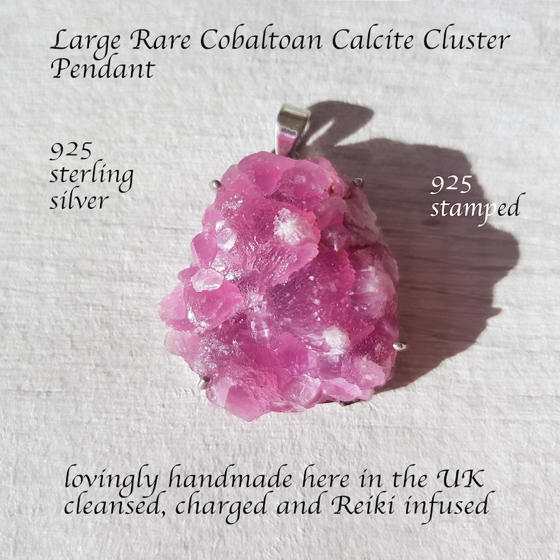 May include: A large, rare Cobaltoan Calcite cluster pendant. The pendant is a vibrant pink color with white accents and a 925 sterling silver bail. The text on the image reads "925 stamped". The pendant is handmade in the UK.