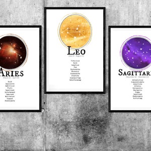 May include: Three framed prints with constellation illustrations and zodiac signs. The signs are Aries, Leo, and Sagittarius. Each print has a black frame and a white background with the constellation in a circle and the zodiac sign name and dates below.