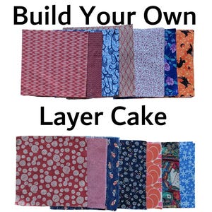 May include: A selection of fabric bundles in diverse patterns and colours. The image features the text "Build Your Own Layer Cake". The fabrics include red, blue, purple, and orange with floral, geometric, and Halloween-themed designs.
