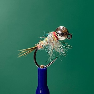 May include: A silver and red fly fishing lure with a feathered tail and a silver bead head.