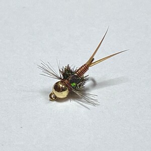 May include: A gold-headed fly fishing lure with a copper body and green and brown feathers.