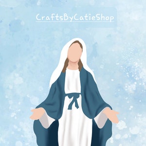 May include: A digital illustration of the Virgin Mary in a blue robe and white dress, standing on a blue watercolor background with white speckles. The text "CraftsByCatieShop" is at the top of the image.
