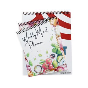 May include: Two spiral-bound weekly meal planners. The front planner features the text "Weekly Meal Planner" with a floral and food illustration. The second planner has a red and white striped design. The word "Examples" is at the bottom.