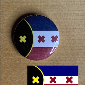 May include: A round button with a black, yellow, blue, white, and red flag design. The flag has a black circle with a yellow outline and a yellow X in the upper left corner. The rest of the flag is divided into three horizontal stripes: blue, white, and red. The white stripe has three red X's.