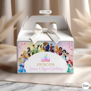 May include: White gift box with a white satin bow. The box features a colorful illustration of Disney princesses and the text "Princess Sienna's Magical Birthday". The box measures 5.75 x 3.25 inches.