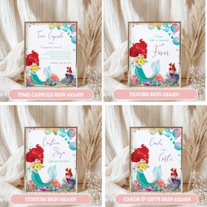May include: Four framed signs with mermaid illustrations and text. The signs read "Time Capsule," "Favors," "Custom Sign," and "Cards & Gifts." Each sign features a mermaid with red hair and a turquoise tail, surrounded by colorful bubbles.
