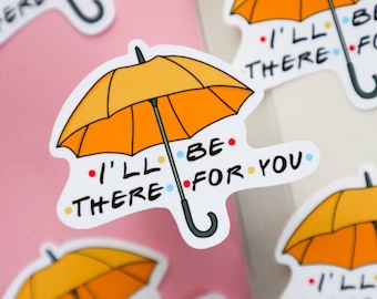 May include: Five yellow umbrella stickers with the text "I'll be there for you" in black, blue, and yellow. The stickers are on a pink surface and a white surface.