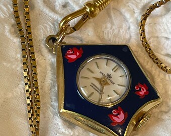 Reloj vintage con caja en forma de estrella dorada, esmalte azul y colgante floral de Harvester