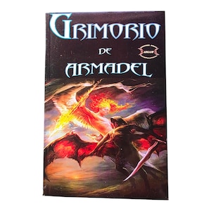 May include: A book titled "Grimorio de Armadel" with a fantasy illustration on the cover. The cover art features a fiery figure with wings, a dark figure with a sword, and a dark background with the AIGAM logo.