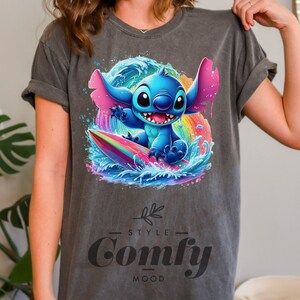 a woman wearing a gray t - shirt with an image of stitching stitching