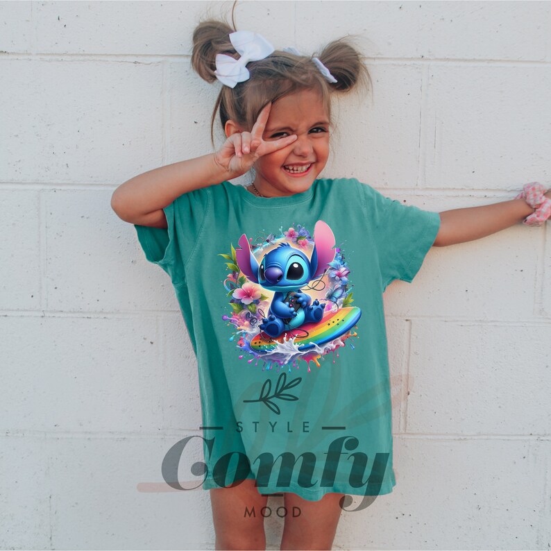 a little girl wearing a t - shirt with an image of stitching stitching