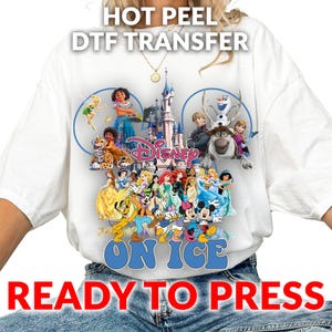 May include: White t-shirt featuring a colorful Disney graphic with characters from various movies, including princesses, Mickey Mouse, and characters from Frozen. The text "ON ICE" and "READY TO PRESS" are displayed in blue and red, respectively. The words "HOT PEEL DTF TRANSFER" are at the top.