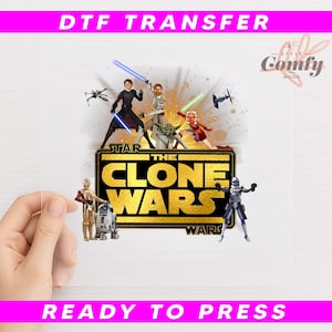 May include: A clear DTF transfer featuring characters from "Star Wars: The Clone Wars" with the text "THE CLONE WARS" in gold. The transfer includes the text "DTF TRANSFER" and "READY TO PRESS" in pink.