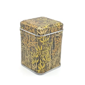 May include: A square, gold and black patterned tin box with a silver rim.