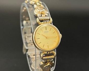 Rare montre à quartz Seiko 1400-2080 pour femme - Boîtier SGP de 20,6 mm avec bracelet dauphin unique