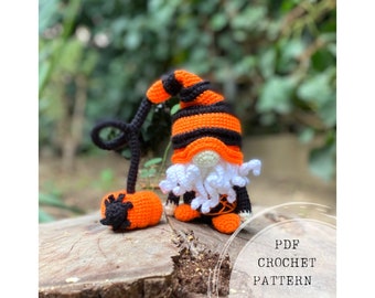 May include: Crochet pattern for a Halloween gnome with an orange and black striped hat, white beard, and a black and orange pumpkin. The pattern is available as a PDF download.