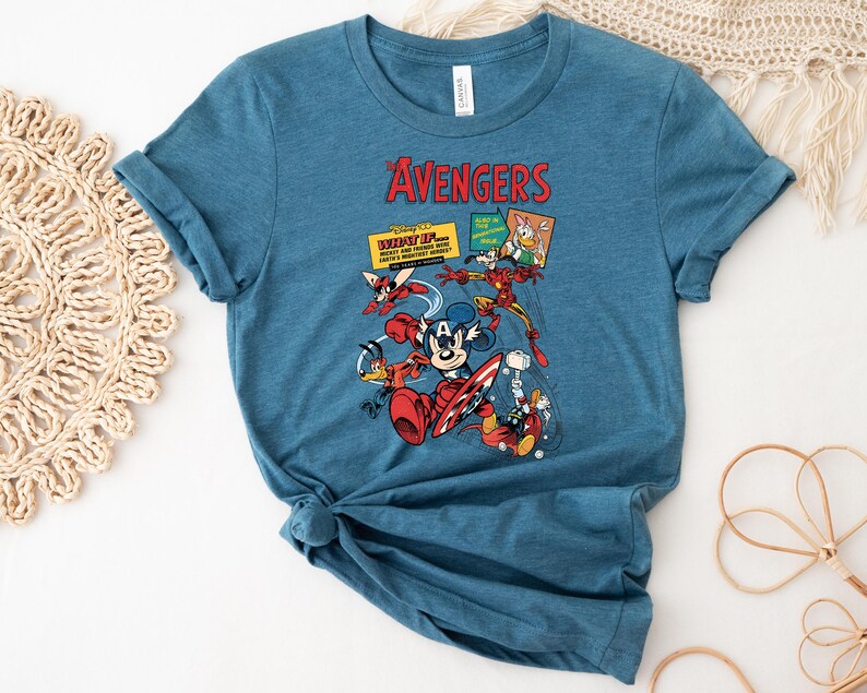 May include: A blue t-shirt with a graphic of Disney characters as The Avengers. The design includes Mickey Mouse, Donald Duck, Iron Man, and Thor. The word "AVENGERS" is printed in red at the top.