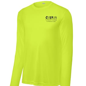 May include: A bright yellow long-sleeved shirt with the text "CUSTOM CREATIONS FLORIDA.COM" printed on the front.