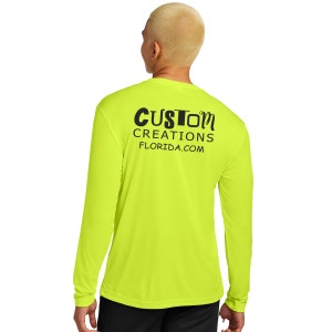 May include: A bright yellow long-sleeve shirt with the text "CUSTOM CREATIONS FLORIDA.COM" printed on the back.