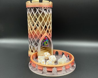May include: A 3D-printed dice tower with a gradient orange and purple finish, featuring a lattice-style cylindrical tower, an internal spiral staircase, a stained-glass window detail, and a circular base containing several polyhedral dice.
