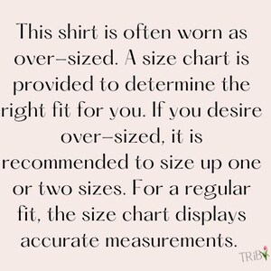 May include: Text on a light pink background reads: "This shirt is often worn as over-sized. A size chart is provided to determine the right fit for you. If you desire over-sized, it is recommended to size up one or two sizes."