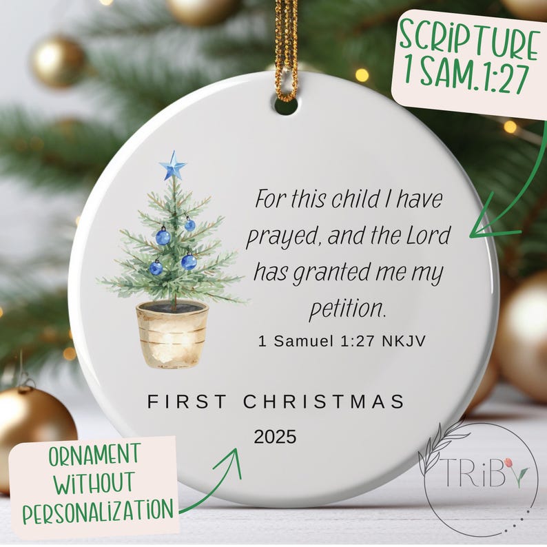 May include: Round white Christmas ornament featuring a watercolour Christmas tree with blue baubles and a star. The text reads "For this child I have prayed..." and "First Christmas 2025".