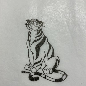 May include: Black and white line drawing of a cartoon tiger sitting with a smile on its face. The tiger has stripes and a long tail. The image is on a white background and includes the copyright symbol and the word "Disney".