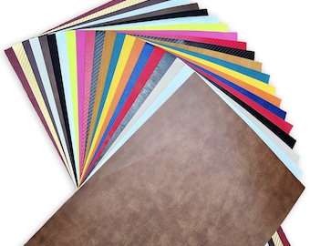 Peut inclure: Un éventail de feuilles de vinyle colorées dans différentes nuances de rouge, orange, jaune, vert, bleu, violet, rose, marron, noir, blanc et gris. Les feuilles sont disposées en éventail, avec la feuille marron en bas.