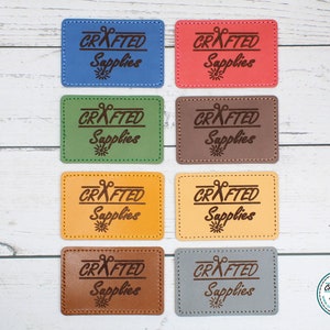 May include: Eight leather labels with the text "CRAFTED Supplies" and a pair of scissors graphic. The labels are in various colors: blue, red, green, brown, yellow, and gray.