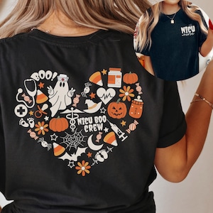 May include: Black t-shirt with a heart-shaped Halloween design. The design includes a ghost, pumpkins, candy corn, and the words "NICU BOO CREW". A smaller image shows a black t-shirt with the words "NICU nurse".