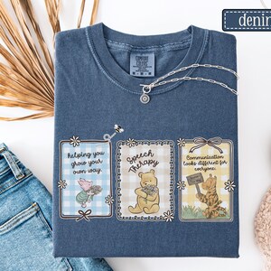 May include: Denim blue Comfort Colors t-shirt with three framed illustrations featuring Winnie the Pooh characters. The frames contain text: "helping you grow your own way," "Speech Therapy," and "Communication looks different for everyone."