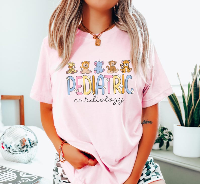 May include: Pink t-shirt with a graphic of cartoon animals and the text "PEDIATRIC cardiology".