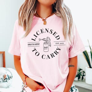 Spray Tan Artist Shirt • Licensed To Carry Spray Tan Artist Work Tshirt • Personalized Spray Tan Tech EST. 2025 Gift • Sunless Tanning Salon Pink