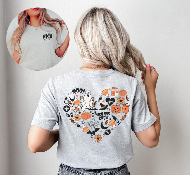 May include: A light gray t-shirt with a heart-shaped Halloween-themed graphic on the back, featuring pumpkins, a ghost, and the text "NICU BOO CREW". The front of the shirt has the text "NICU nurse".