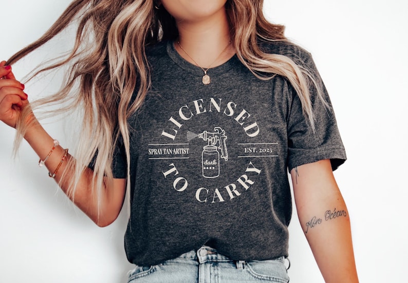 Spray Tan Artist Shirt • Licensed To Carry Spray Tan Artist Work Tshirt • Personalized Spray Tan Tech EST. 2025 Gift • Sunless Tanning Salon Dark Grey Heather