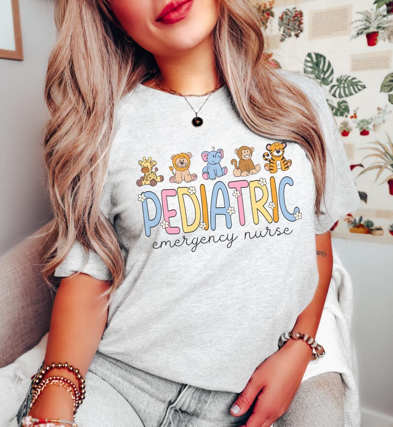 May include: A gray t-shirt with a colorful graphic of cartoon animals and the text "PEDIATRIC emergency nurse".