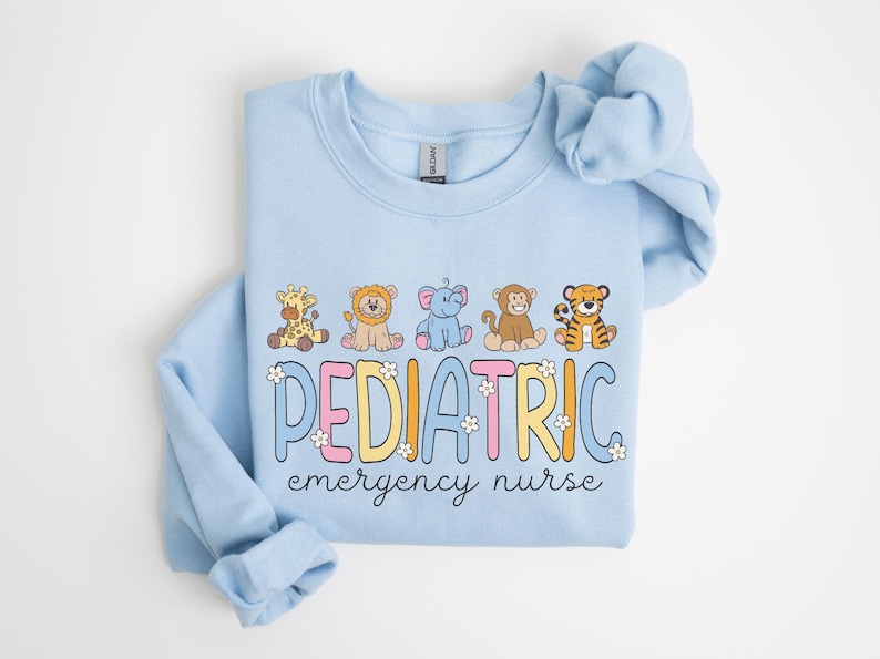 May include: Light blue sweatshirt with a graphic of cartoon animals and the text "PEDIATRIC emergency nurse".