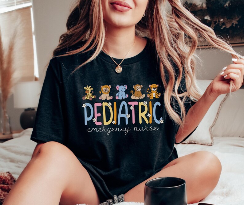 May include: Black t-shirt with a graphic of cartoon animals and the text "PEDIATRIC emergency nurse".