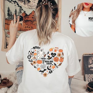 May include: White t-shirt with a heart-shaped Halloween design on the back, featuring a ghost, pumpkins, and the text "NICU BOO CREW." A smaller image shows a white t-shirt with the text "NICU nurse."