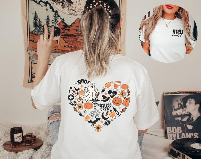 May include: White t-shirt with a heart-shaped Halloween design on the back, featuring a ghost, pumpkins, and the text "NICU BOO CREW." A smaller image shows a white t-shirt with the text "NICU nurse."