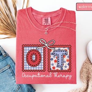 May include: A watermelon-colored t-shirt with the letters "OT" in a postage stamp design. The "O" is red with a blue and white gingham background, and the "T" is blue with a floral background. The words "Occupational Therapy" are written below.